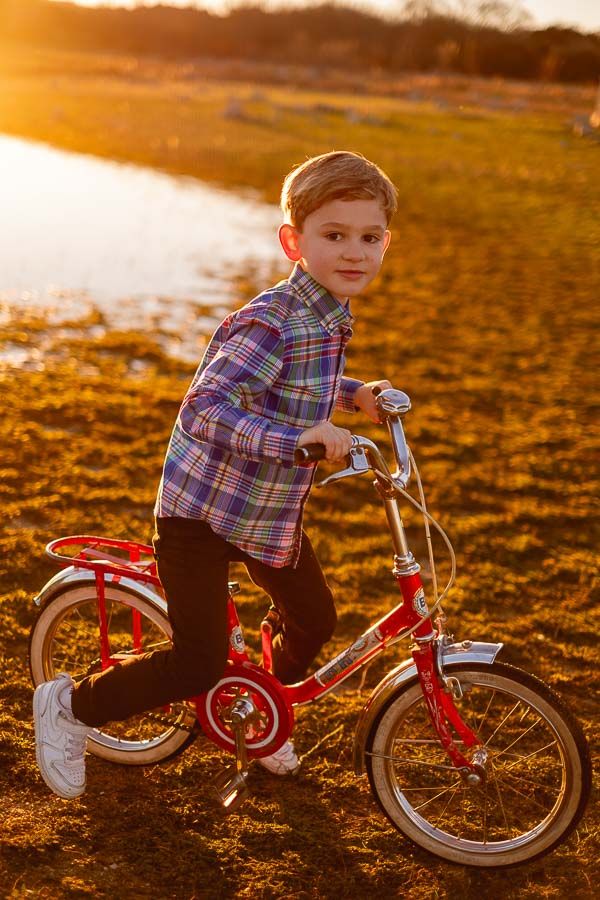 Retrato natural de hermanos jugando en el campo con bicicleta